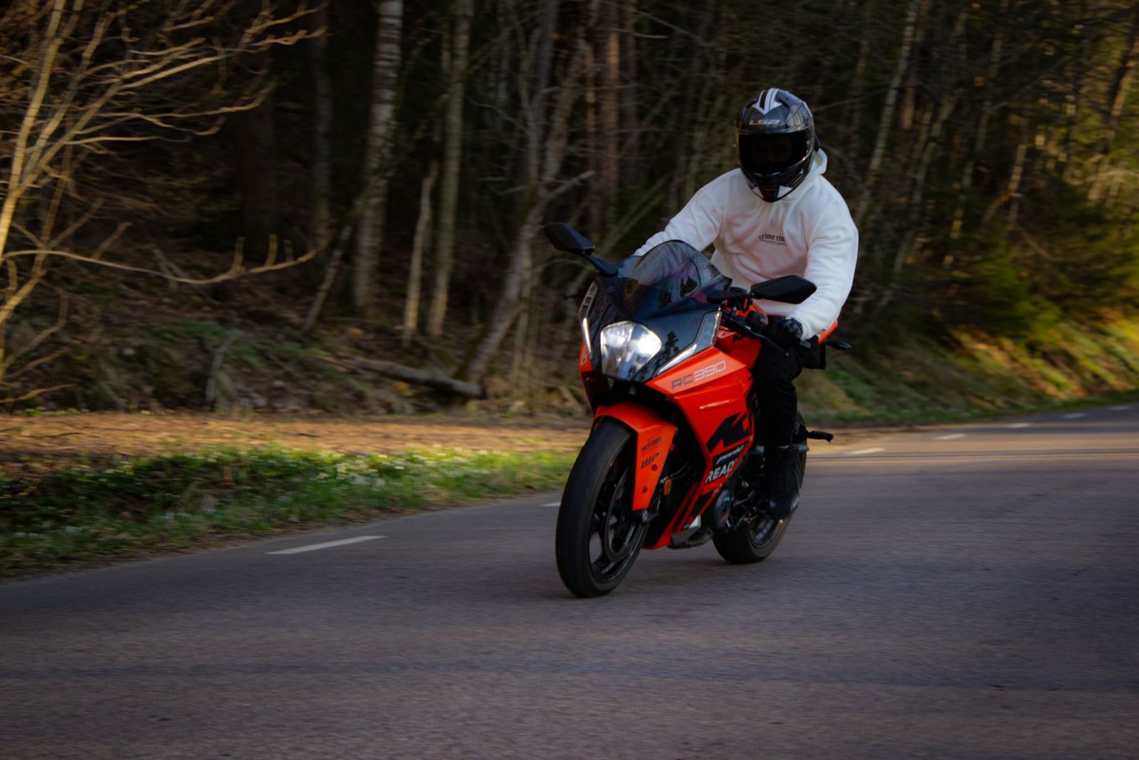 Motorcyklist i fart på skogsväg